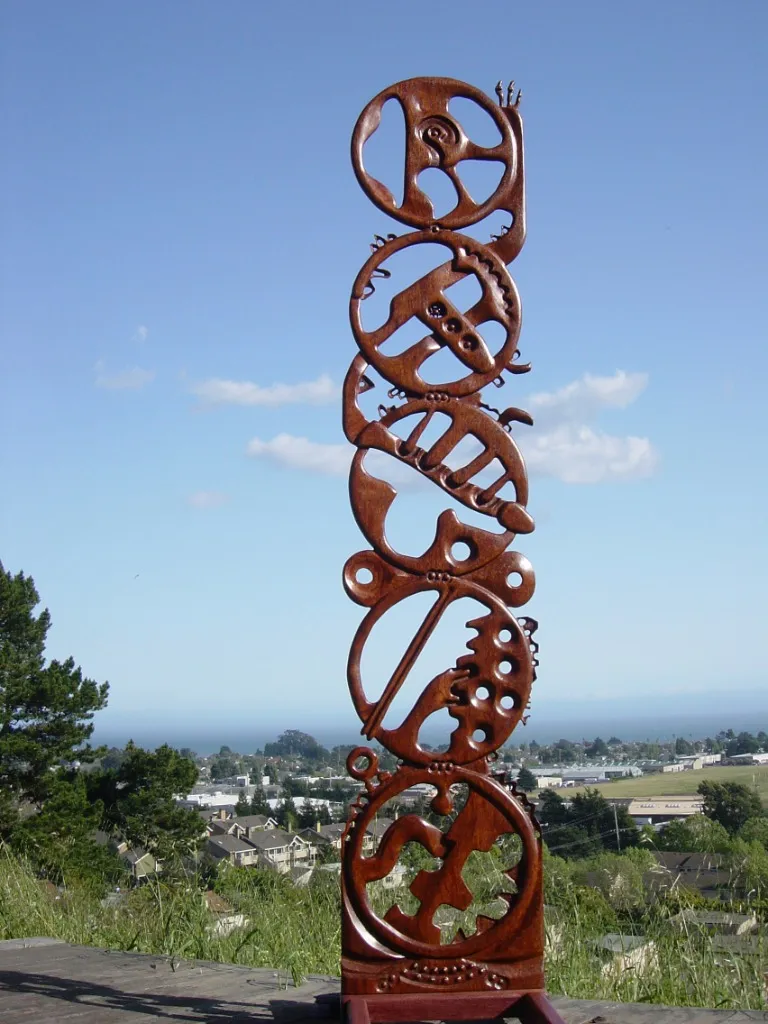 Carved wood totem, reflecting the traditional woodcarving training.